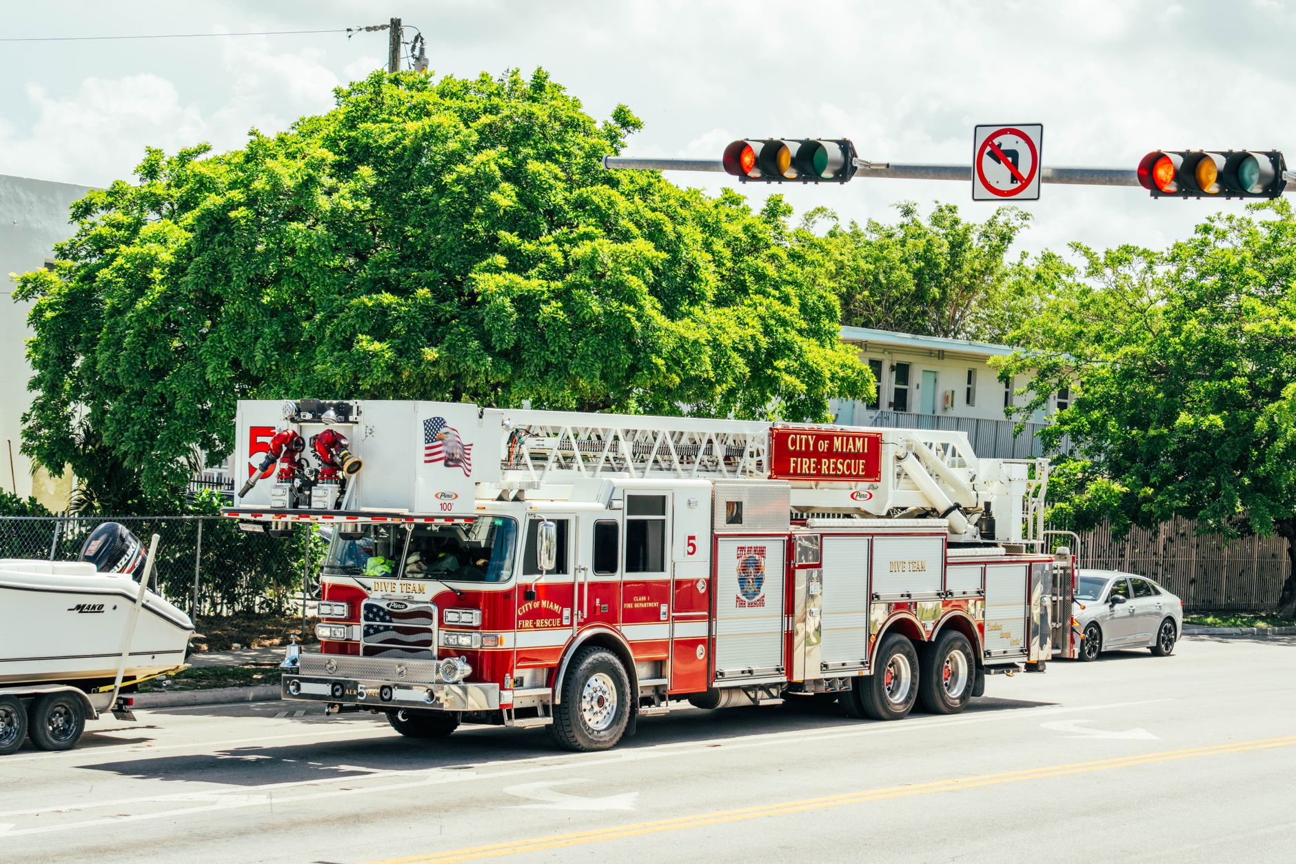 Miami fire-rescue truck with dive team module parked on a sunny street.
